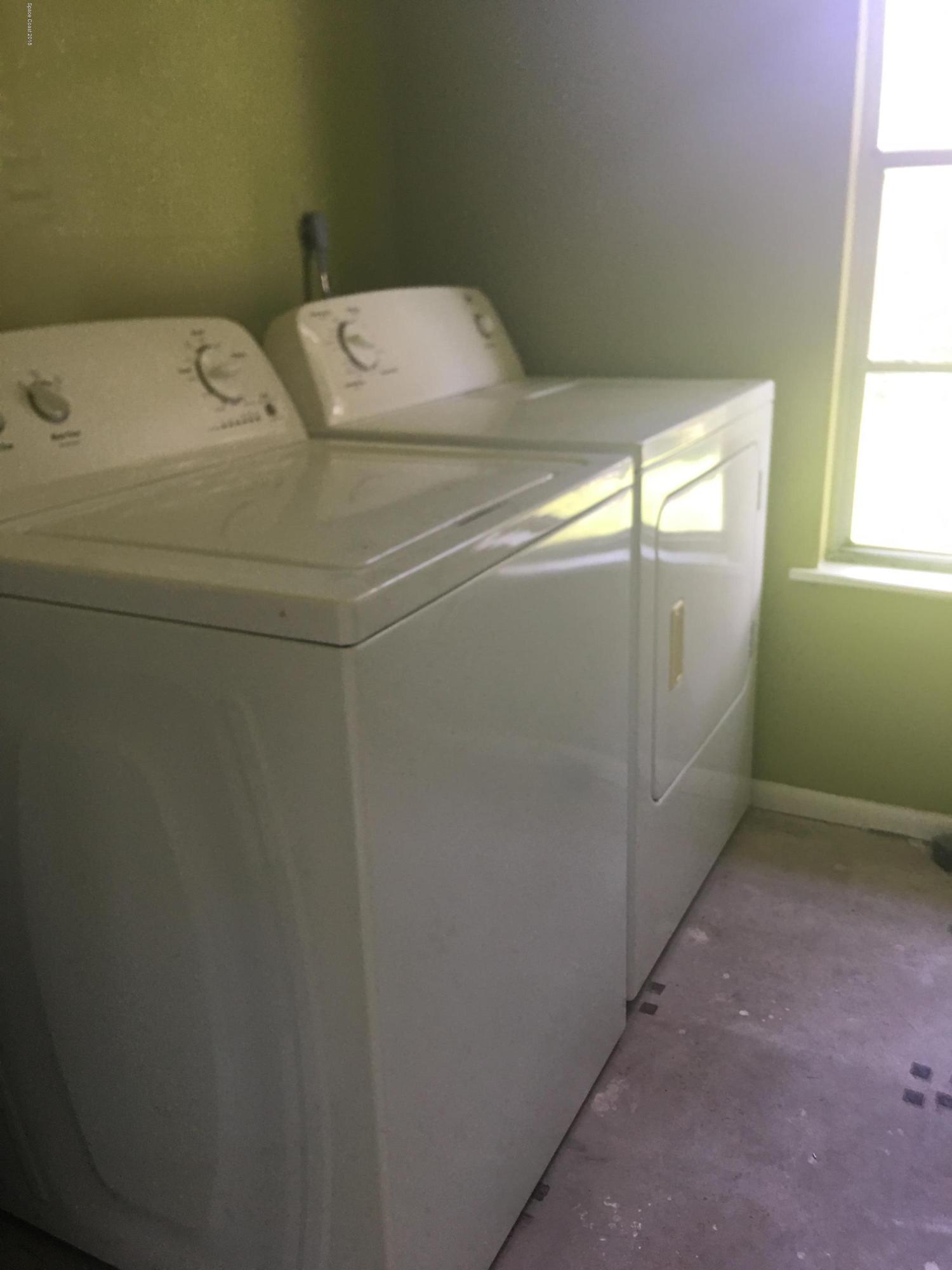1272 Cromey Road Northeast Palm Bay, FL 32905 - Photo 36 of 53 a utility room with dryer and washer