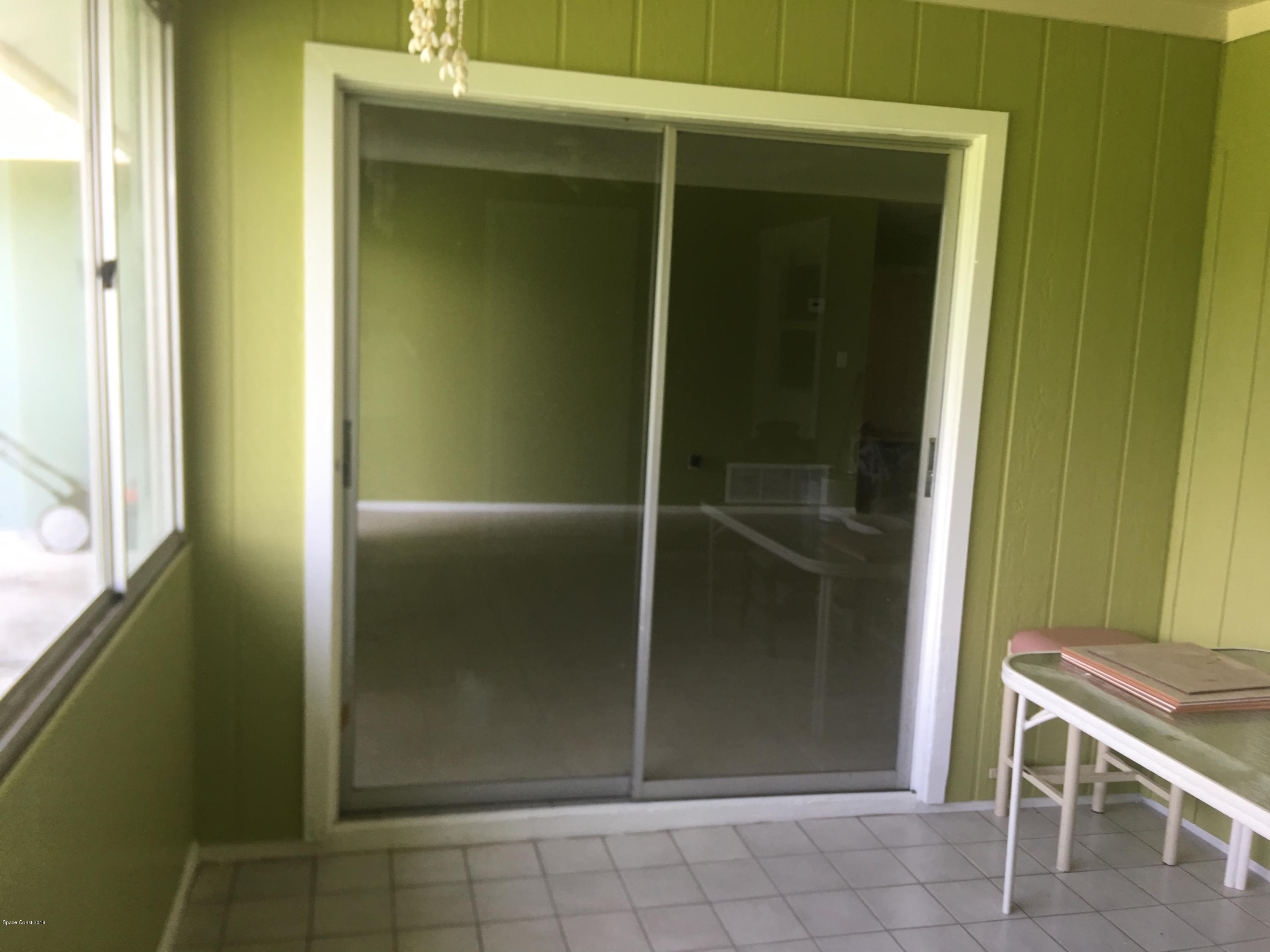 1272 Cromey Road Northeast Palm Bay, FL 32905 - Photo 5 of 53 a room with a door
