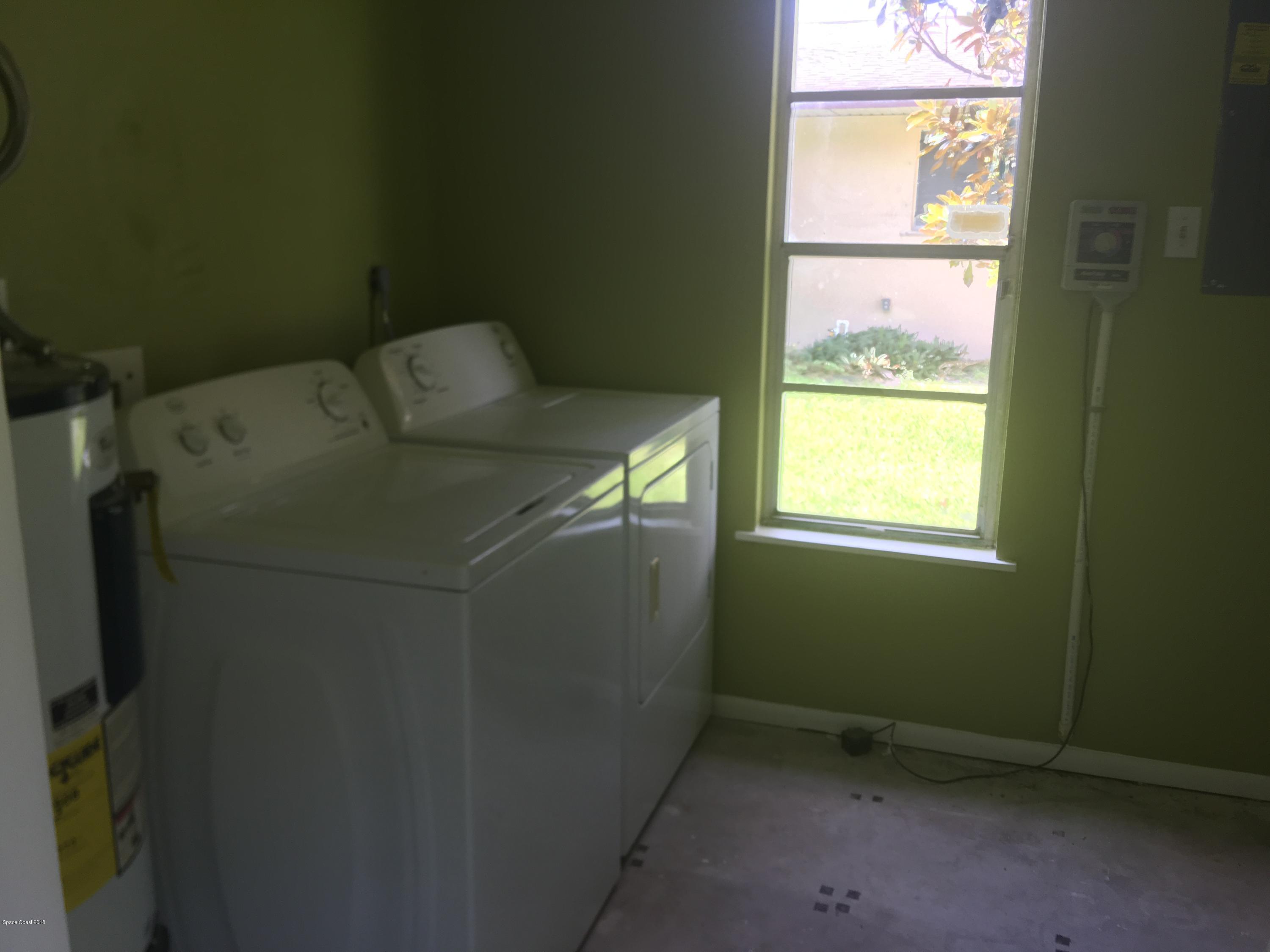 1272 Cromey Road Northeast Palm Bay, FL 32905 - Photo 8 of 53 a utility room with dryer and window