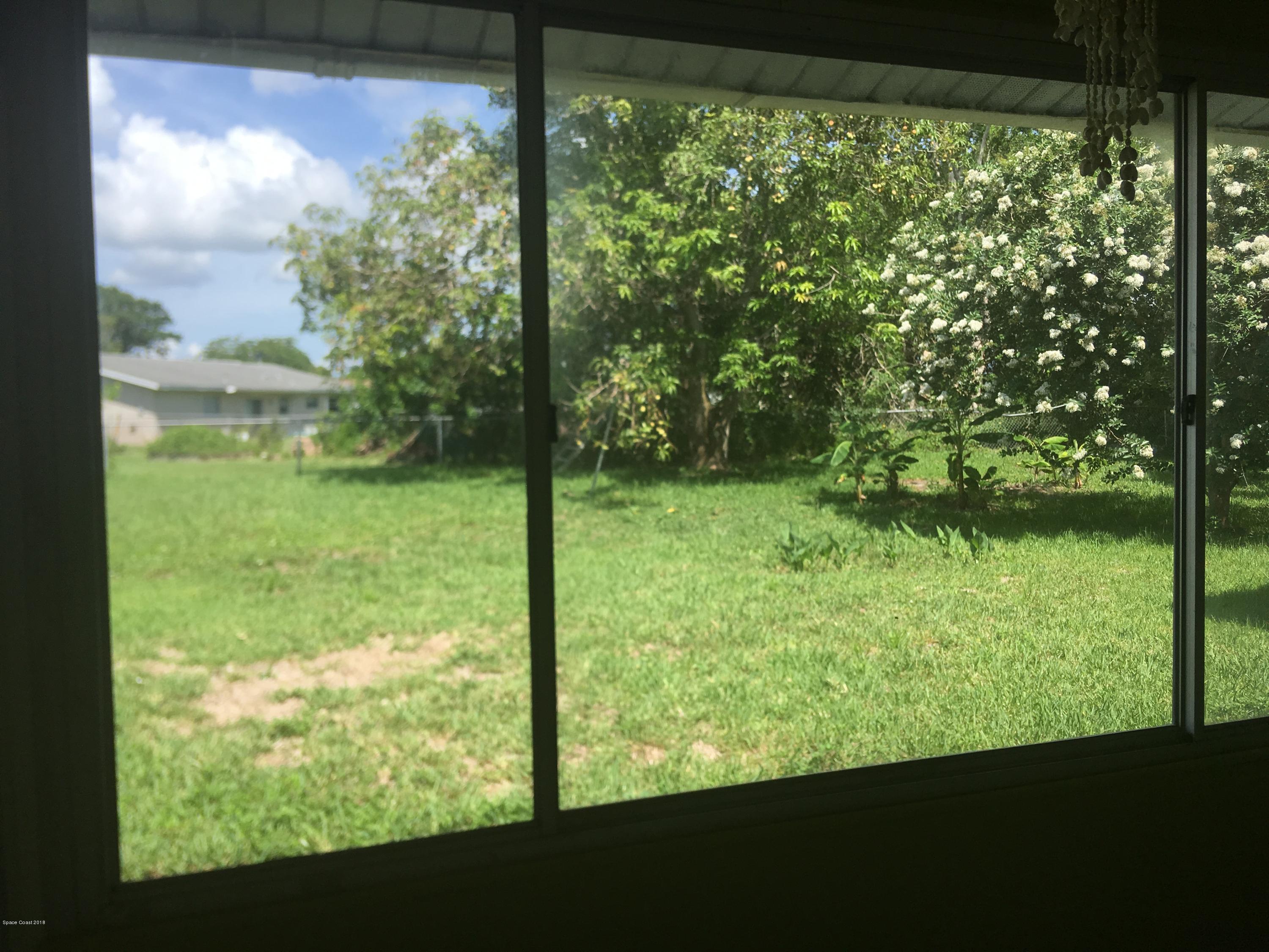 1272 Cromey Road Northeast Palm Bay, FL 32905 - Photo 9 of 53 a view of a yard from a window