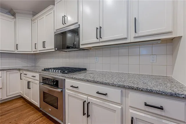 a bathroom with a double vanity sink toilet and shower