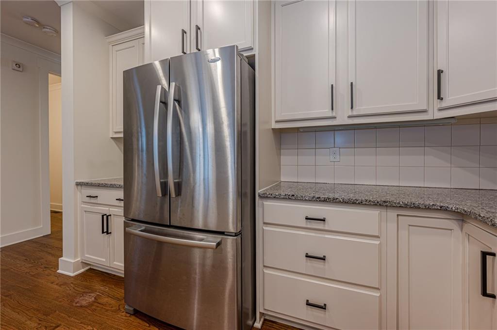 247 Fowler Street Woodstock, GA 30188 - Photo 19 of 72 a kitchen with stainless steel appliances granite countertop a refrigerator and a stove top oven