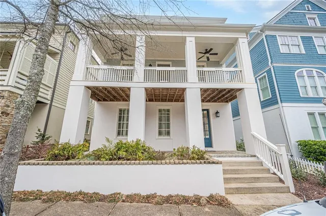 a front view of a multi story residential apartment building with yard and sign board