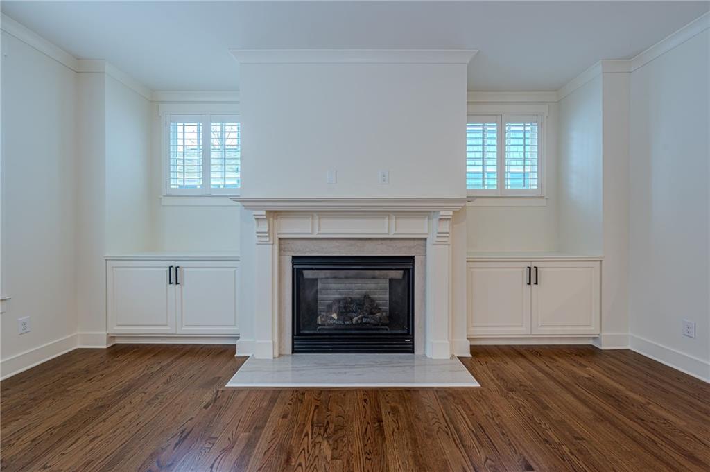 247 Fowler Street Woodstock, GA 30188 - Photo 21 of 72 an empty room with wooden floor and fireplace