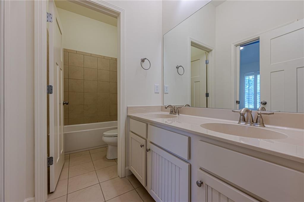 247 Fowler Street Woodstock, GA 30188 - Photo 27 of 72 a bathroom with a double vanity sink toilet and shower