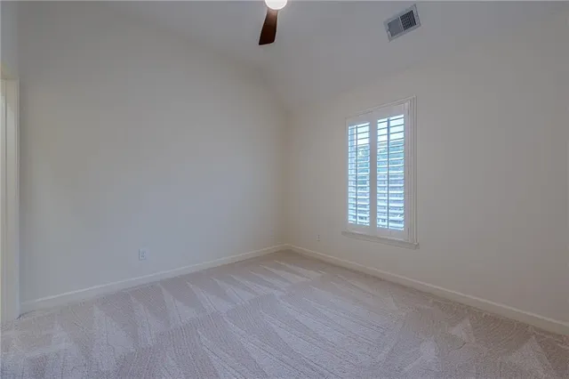 a view of a wooden deck with large windows