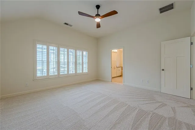 a view of a wooden deck with chairs and a small yard
