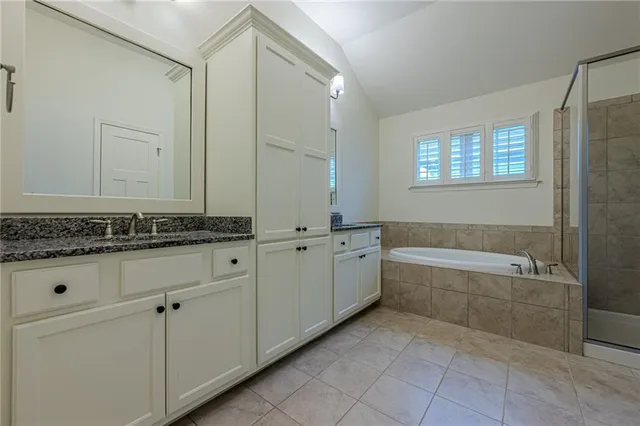 a view of a street with potted plants and large trees