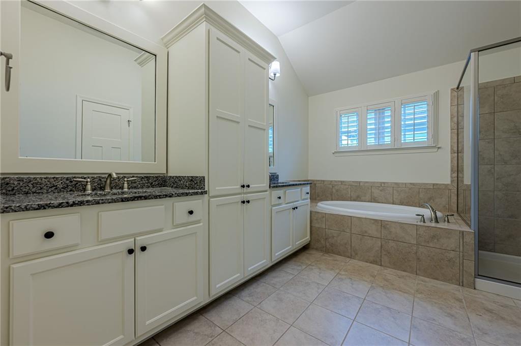 247 Fowler Street Woodstock, GA 30188 - Photo 38 of 72 a bathroom with a granite countertop bathtub sink and mirror