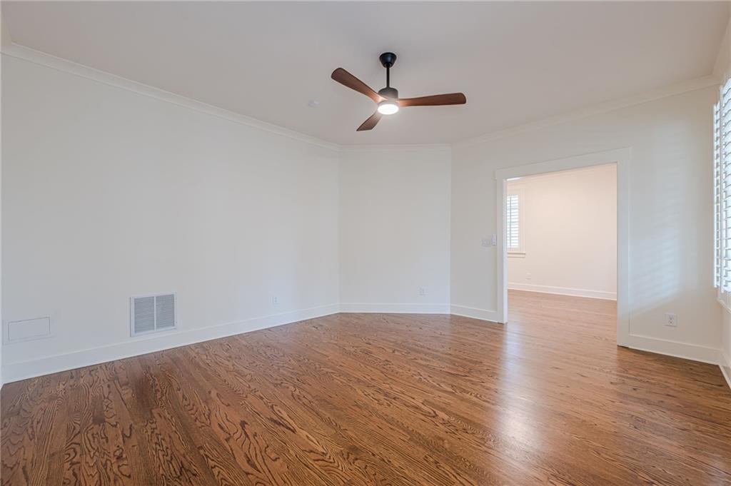247 Fowler Street Woodstock, GA 30188 - Photo 50 of 72 an empty room with wooden floor a ceiling fan and windows