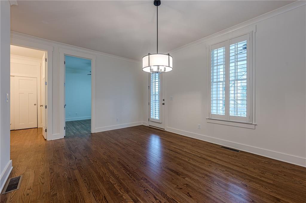 247 Fowler Street Woodstock, GA 30188 - Photo 9 of 72 a view of empty room with wooden floor and fan