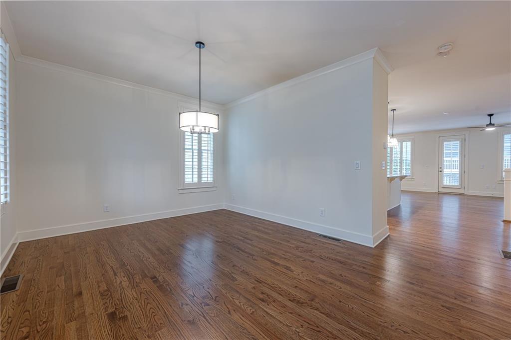 247 Fowler Street Woodstock, GA 30188 - Photo 10 of 72 a view of a room with wooden floor chandelier and windows