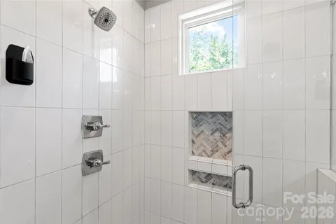 a bathroom with a bathtub and shower