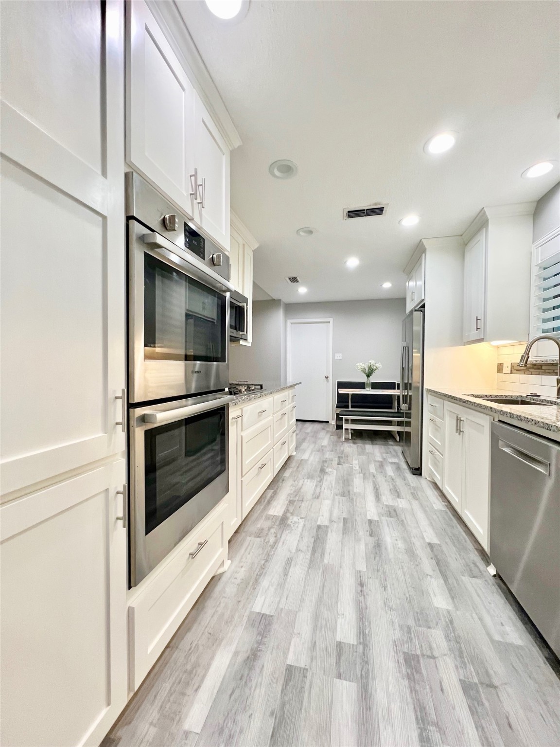 2101 Roland Rue Street Pearland, TX 77581 - Photo 4 of 12 a large white kitchen with stainless steel appliances