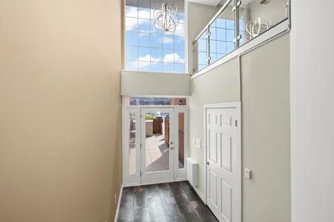 a view of a hallway with wooden floor and entryway
