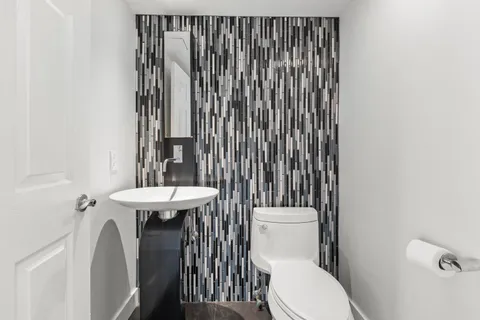 a bathroom with a sink a toilet and tub