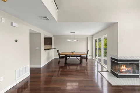 a dining room with furniture and wooden floor