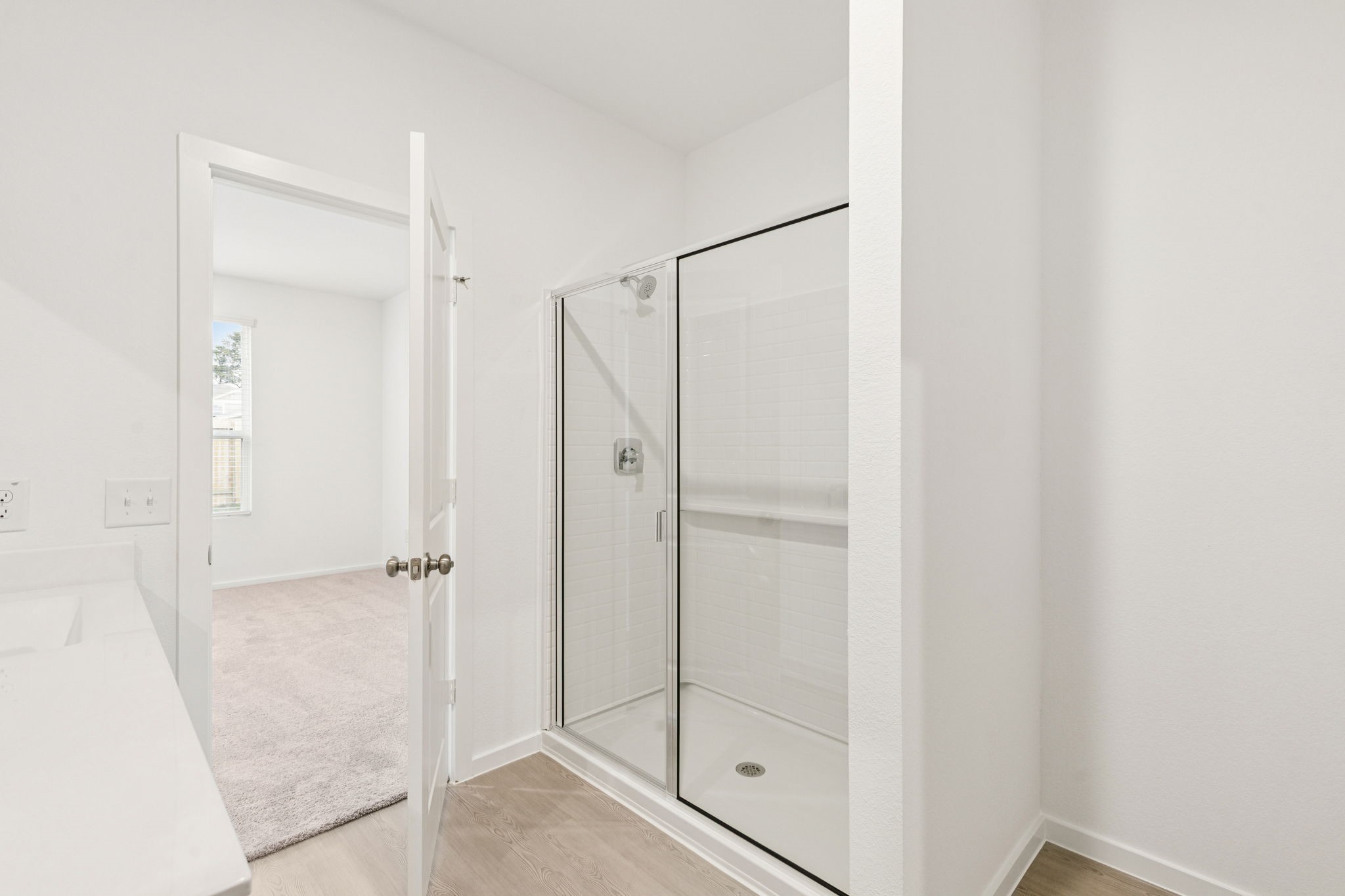 26279 Arrowleaf Drive Magnolia, TX 77355 - Photo 19 of 35 a bathroom with a glass shower door