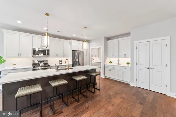 a large kitchen with stainless steel appliances kitchen island a large island in the center