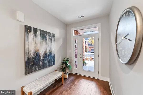 a view of an entryway with wooden floor and door