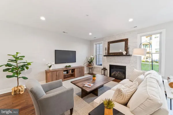 a living room with furniture a fireplace and a flat screen tv