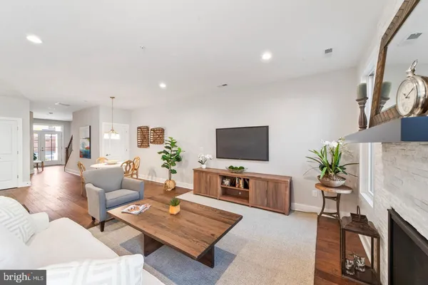 a living room with furniture a flat screen tv and a fireplace