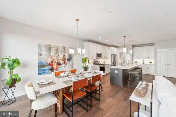 a living room with furniture a flat screen tv and a kitchen view
