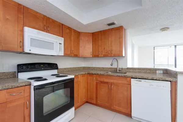 a kitchen with a stove top oven and cabinets
