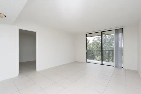 an empty room with sliding glass door and glass door