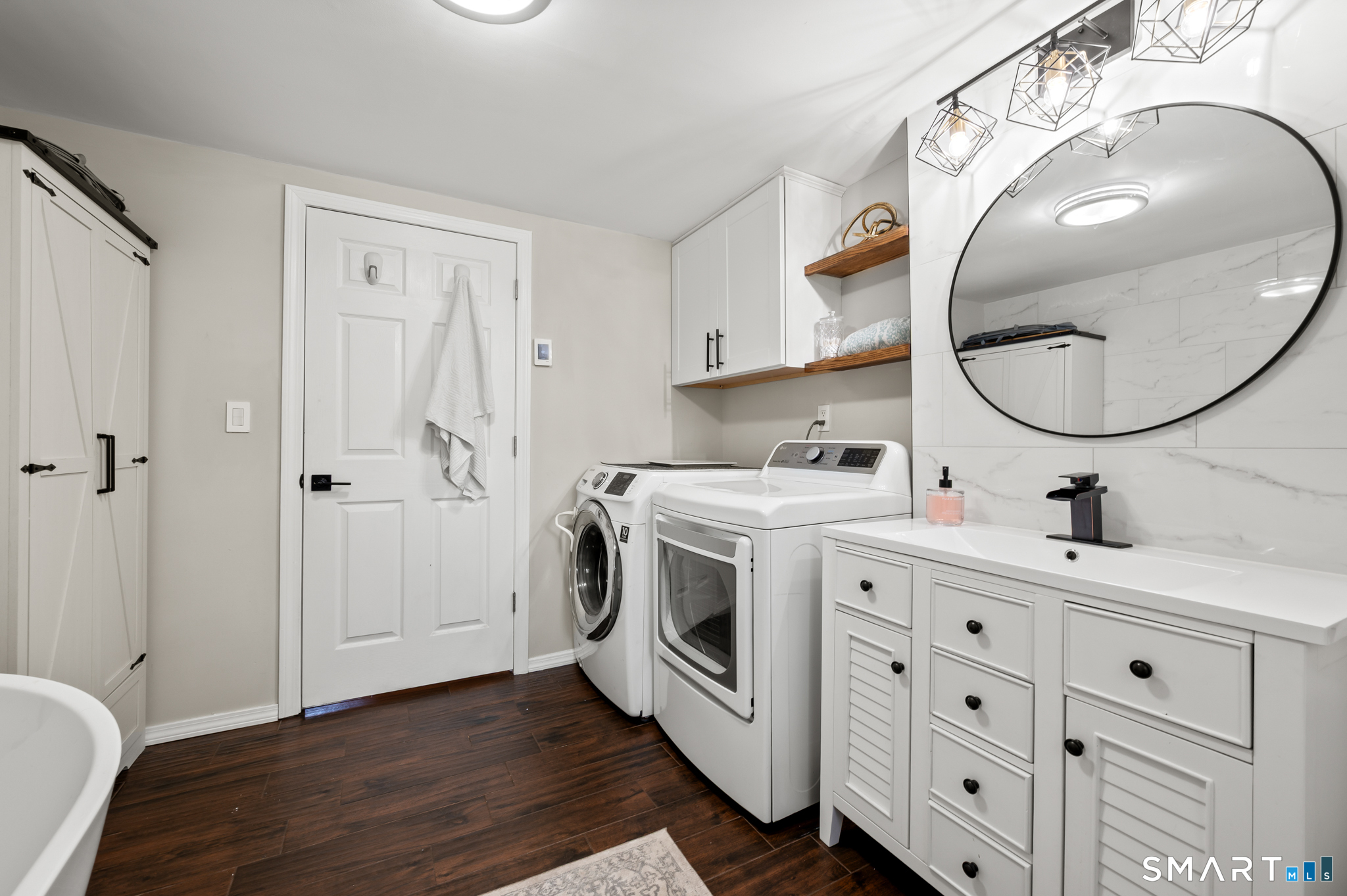 201 Ridge Crest Circle Wethersfield, CT 06109 - Photo 20 of 35 a utility room with cabinets and a wooden floor