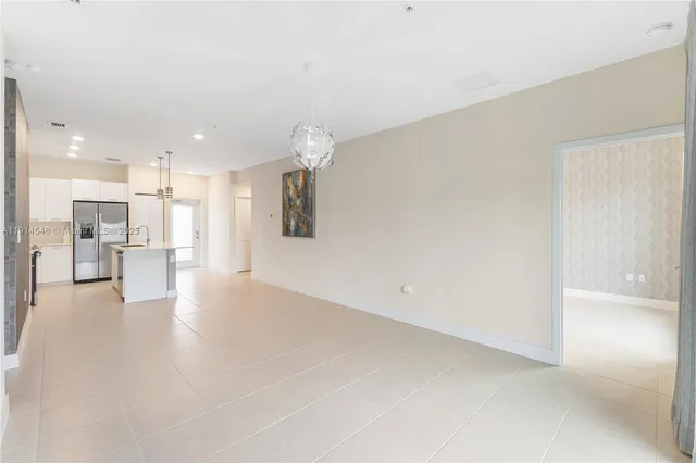 a view of a kitchen with a refrigerator and a window