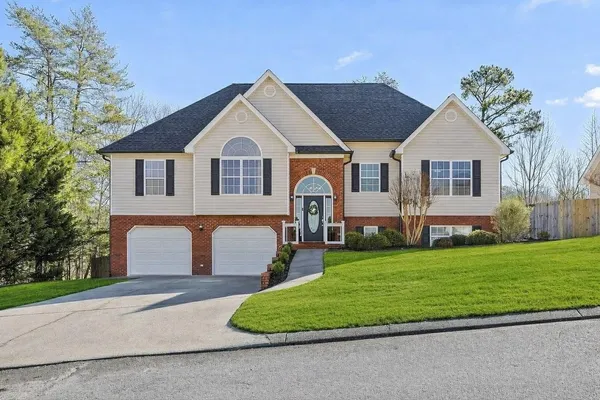 a front view of a house with a yard and garage