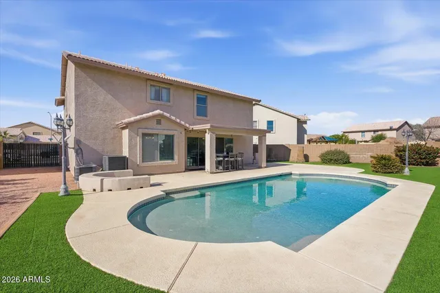 an aerial view of a house with a garden and swimming pool