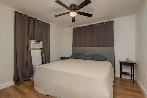 a bedroom with a bed and a chandelier
