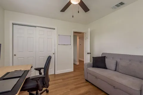 a living room with furniture and a wooden floor