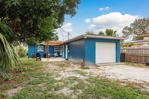 a view of a house with a yard and garage