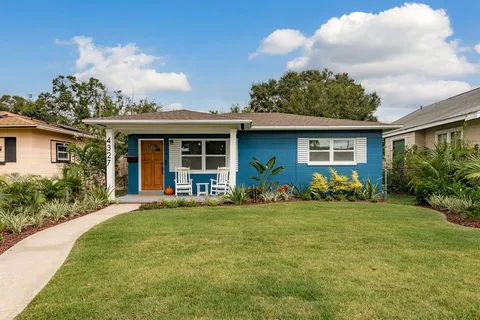 a front view of house with yard and green space