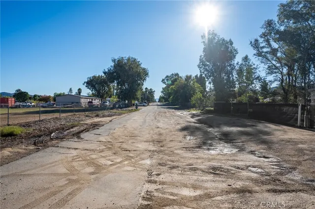 a view of dirt yard with a large tree