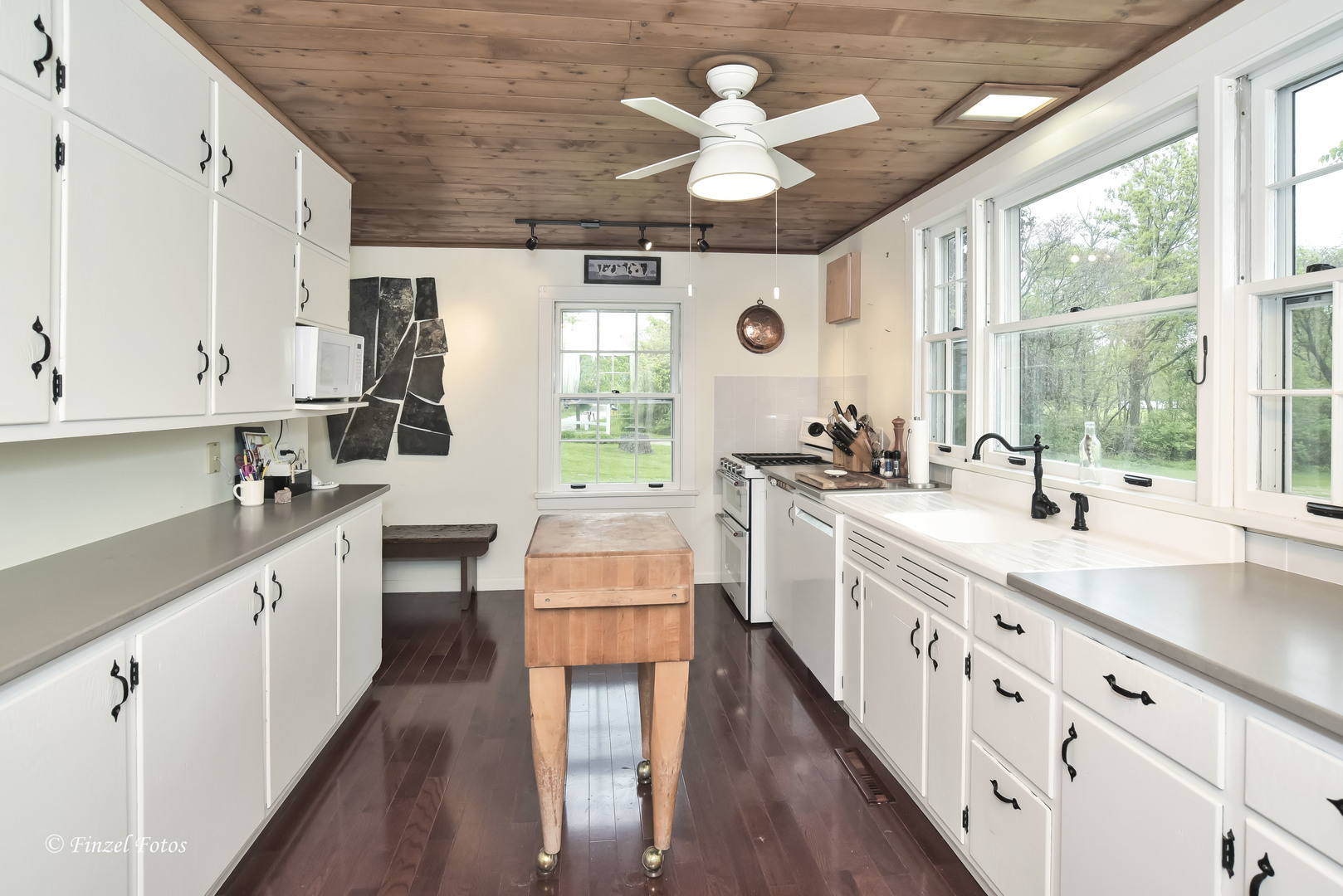 9313 Bull Valley Road Bull Valley, IL 60098 - Photo 11 of 31 a large white kitchen with stainless steel appliances granite countertop a white cabinets a sink dishwasher and a stove with wooden floor