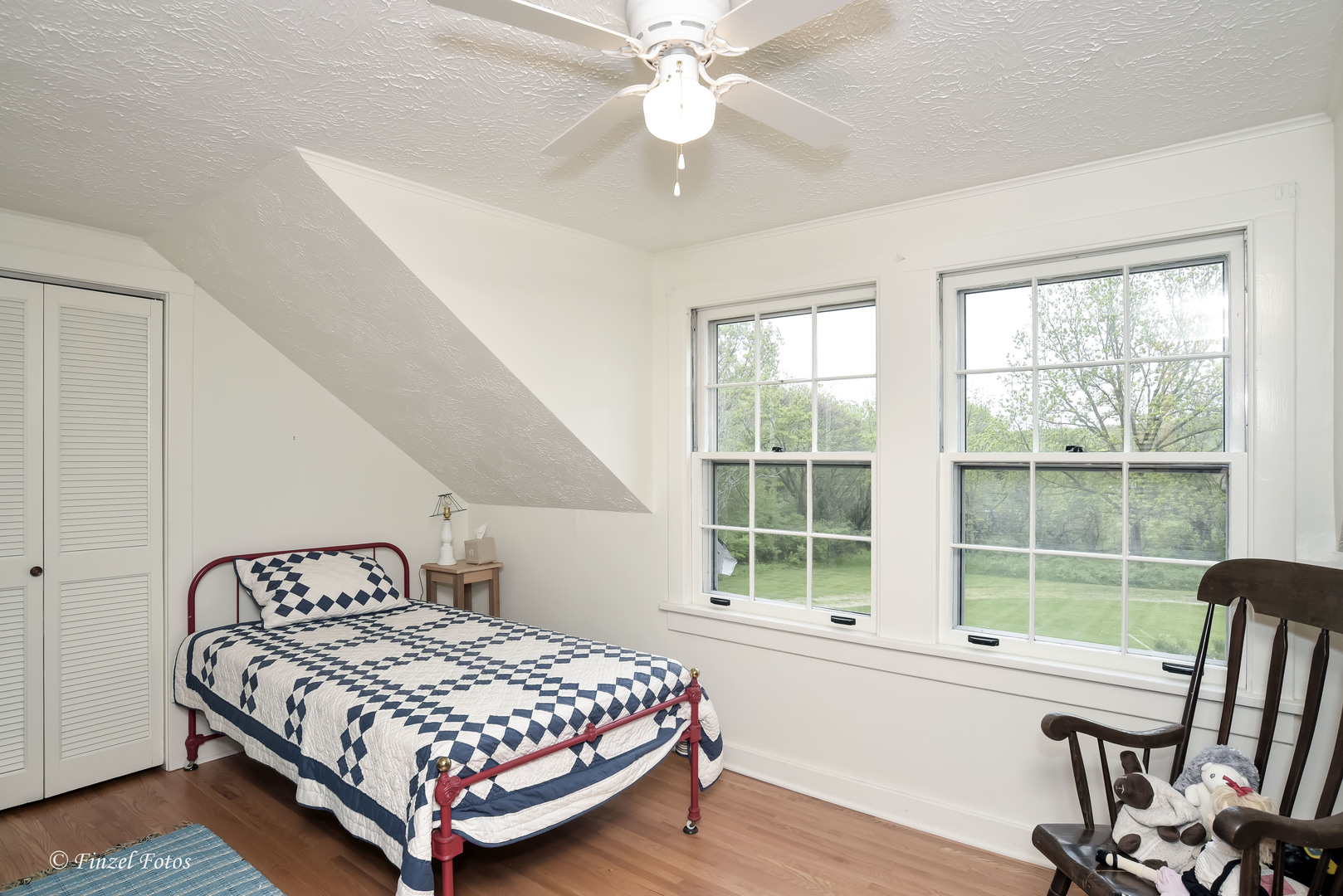 9313 Bull Valley Road Bull Valley, IL 60098 - Photo 15 of 31 a bedroom with a bed and a large window with wooden floor