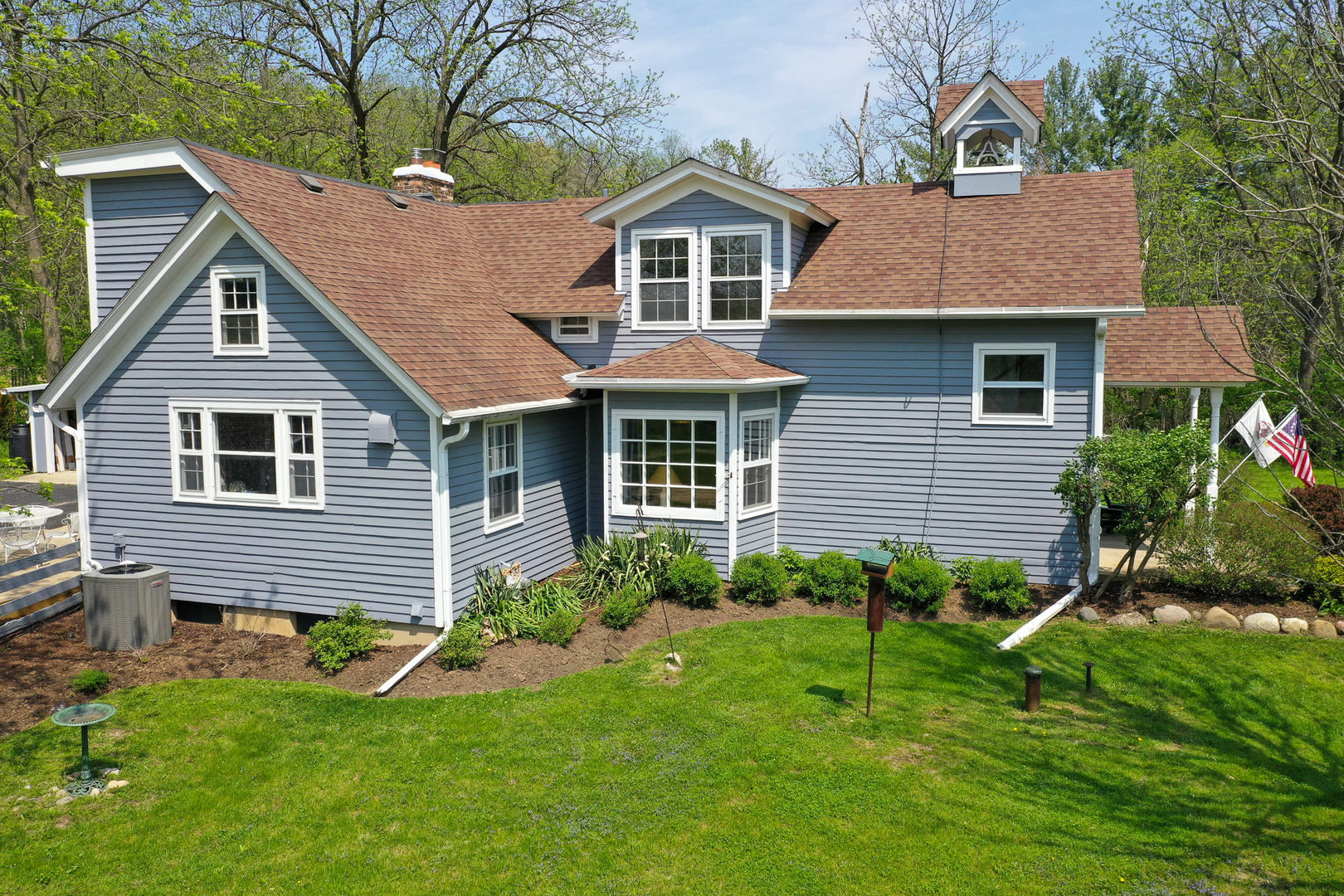 9313 Bull Valley Road Bull Valley, IL 60098 - Photo 24 of 31 a front view of a house with a garden and plants