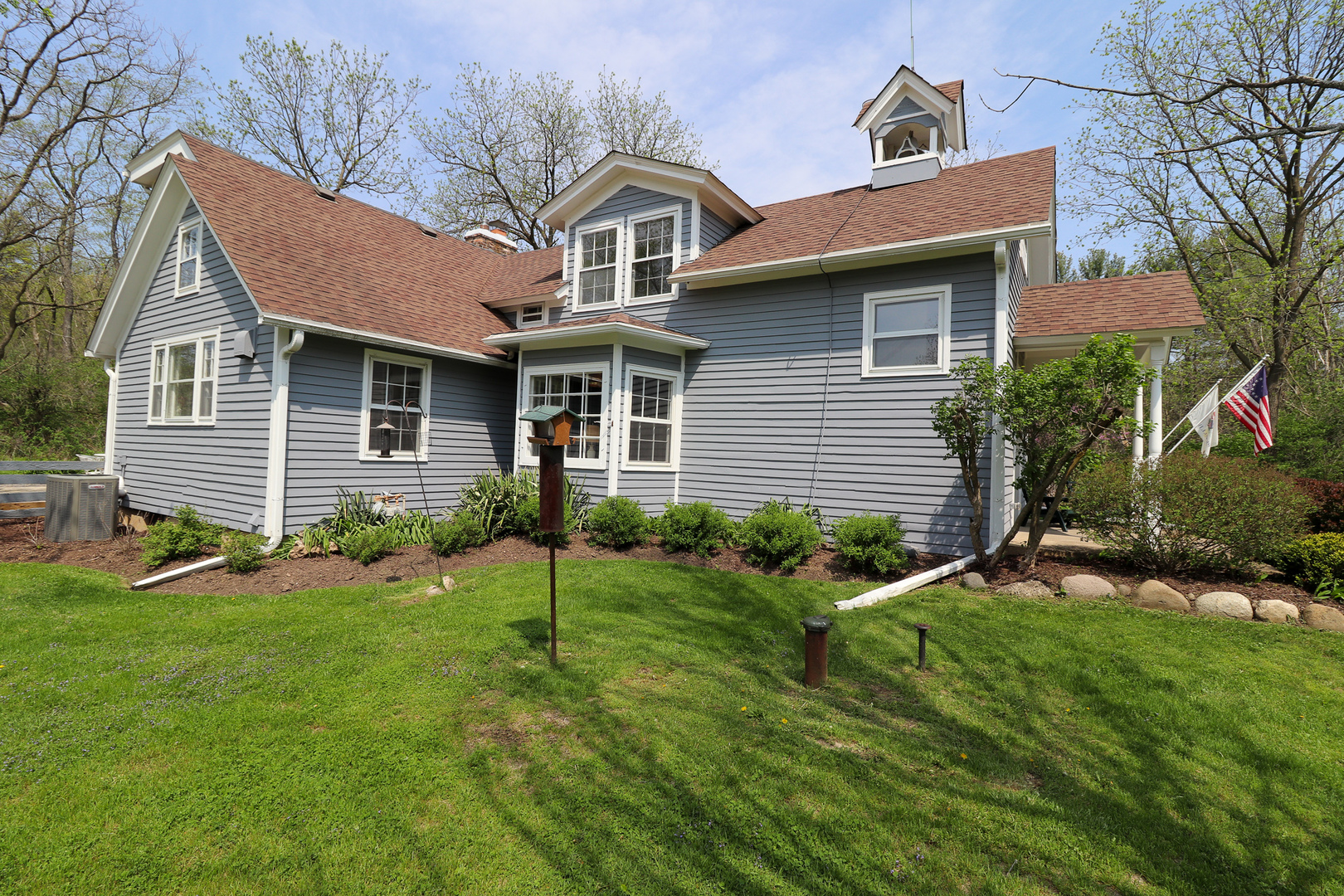 9313 Bull Valley Road Bull Valley, IL 60098 - Photo 25 of 31 a front view of a house with a yard and garage