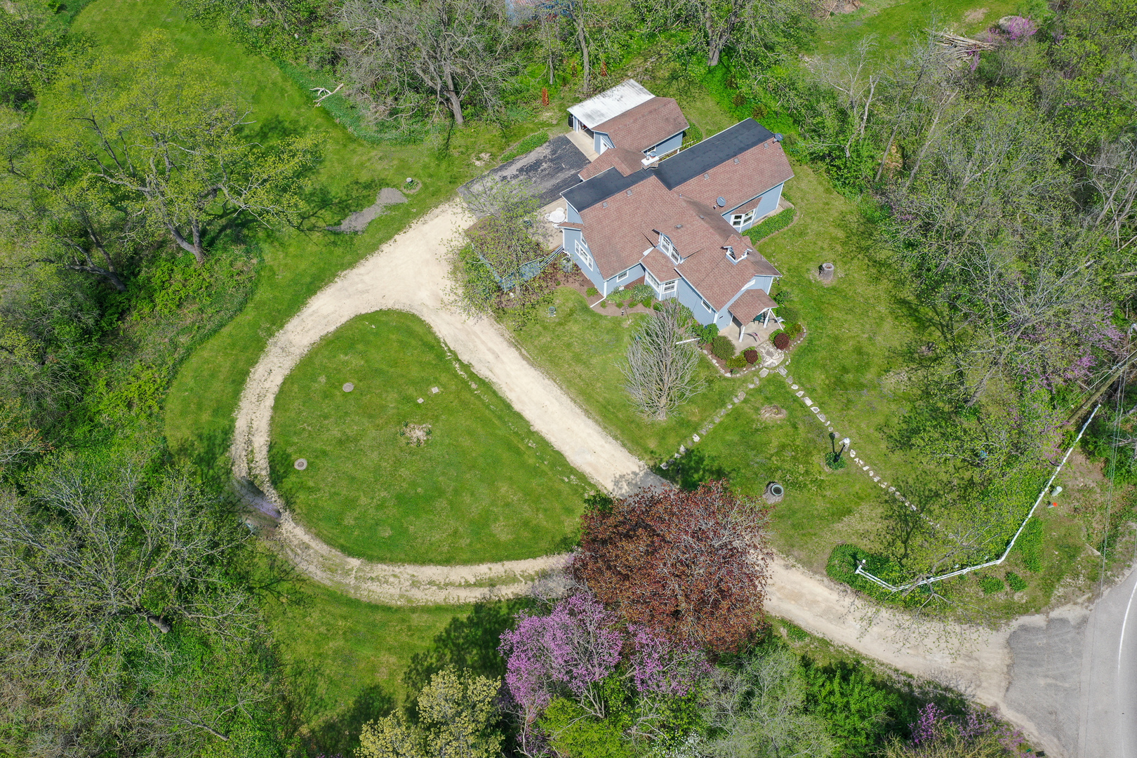 9313 Bull Valley Road Bull Valley, IL 60098 - Photo 31 of 31 an aerial view of a house with a yard and trees all around