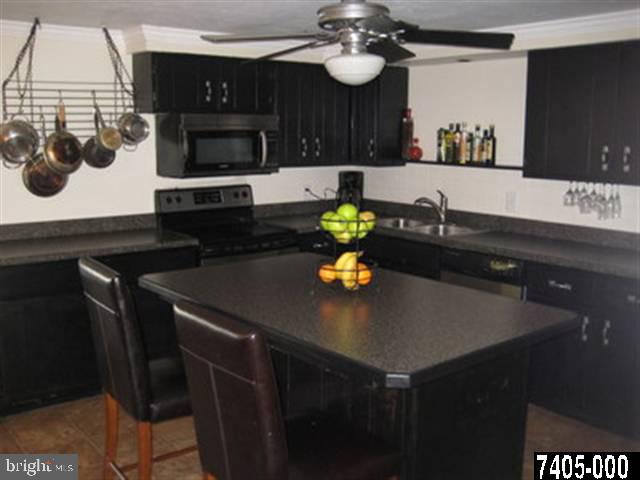 2213 Chestnut Road York, PA 17408 - Photo 2 of 25 a kitchen with a sink and a stove