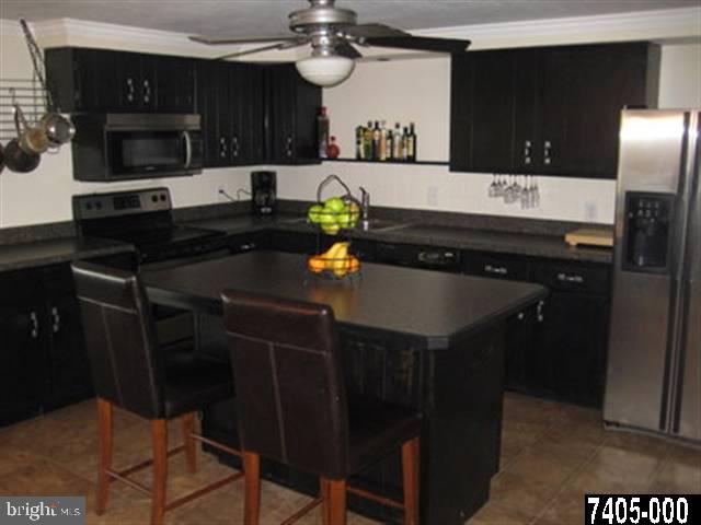 2213 Chestnut Road York, PA 17408 - Photo 3 of 25 a kitchen with a sink cabinets and stainless steel appliances