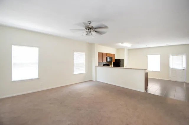a view of a kitchen with furniture and a ceiling fan