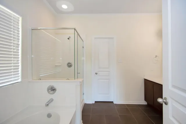 a bathroom with a bathtub and a shower