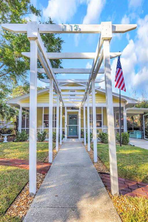 116 Read Street Tarpon Springs, FL 34689 - Photo 12 of 49 a view of a house with a big yard and potted plants