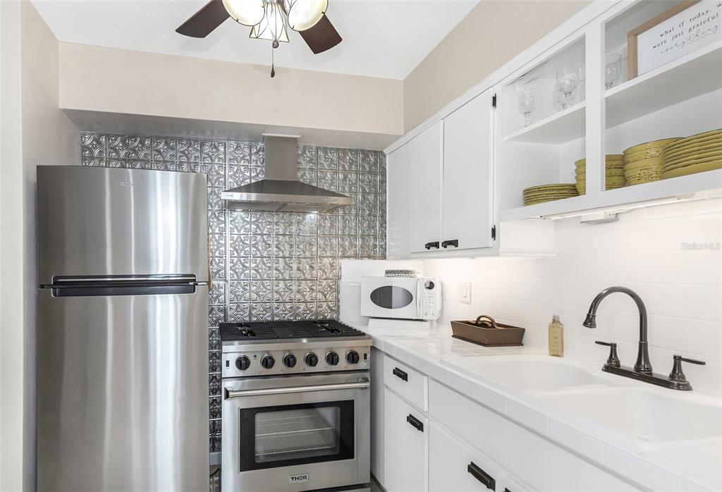 116 Read Street Tarpon Springs, FL 34689 - Photo 25 of 49 a kitchen with a stove and a refrigerator