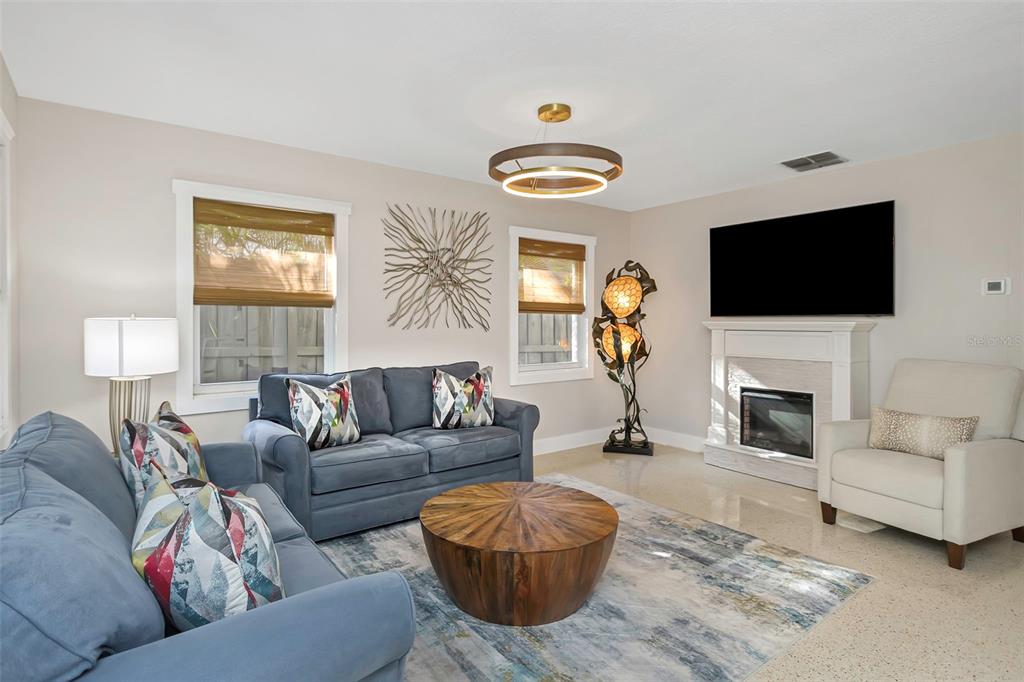 116 Read Street Tarpon Springs, FL 34689 - Photo 35 of 49 a living room with fireplace furniture and a flat screen tv